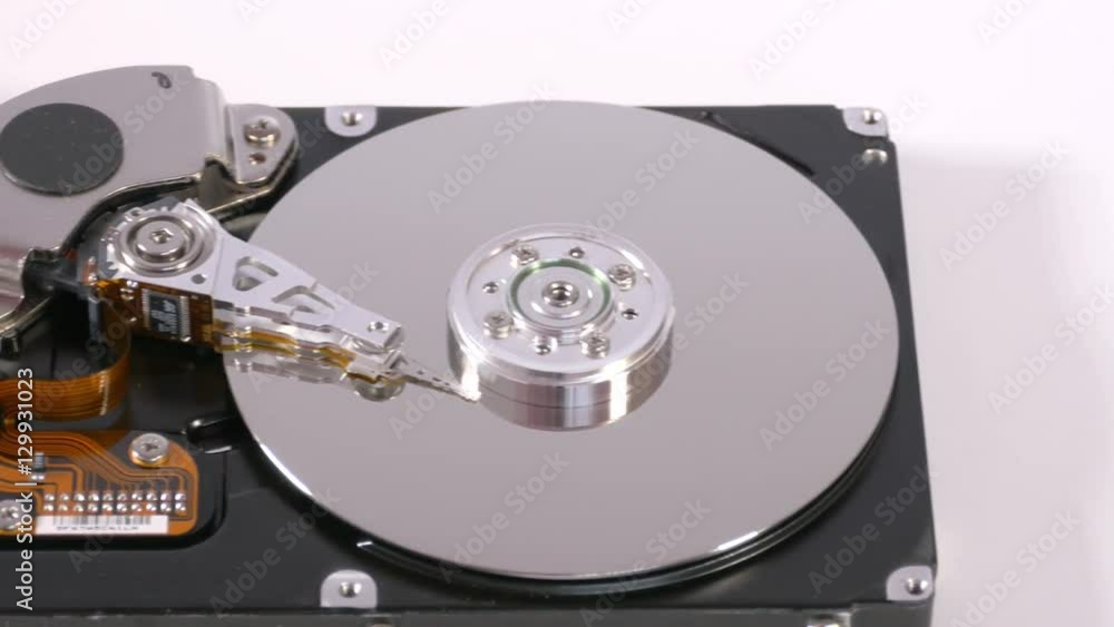 Data storage device,mechanism from inside on white surface, internals of hard disk drive, technology for retrieving digital information. Close up, 4K Ultra HD. Data storage device,mechanism from inside on white surface, internals of hard disk drive, technology for retrieving digital information. Close up, 4K Ultra HD.