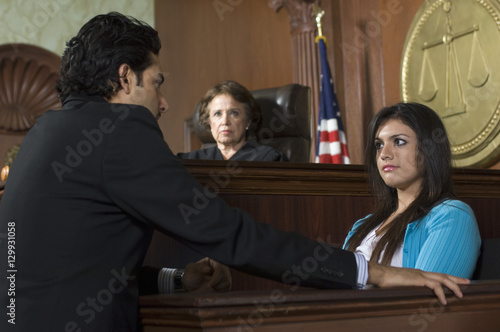 Canvas Print A lawyer questioning a witness in front of female judge in a courtroom