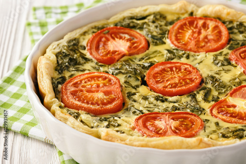Homemade quiche with spinach, feta cheese and tomatoes.