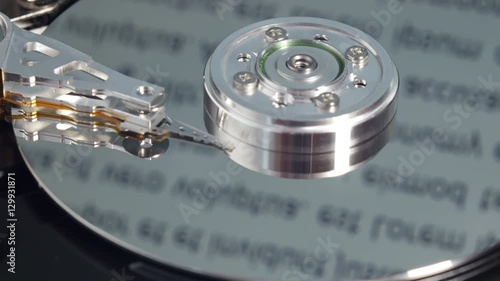 Wallpaper Mural Read-write head touches spindle and starts rotation, moves again across magnetic platter and stops it, text running along reflective surface, inside of hard disk drive. Extreme close up, 4K Ultra HD. Torontodigital.ca