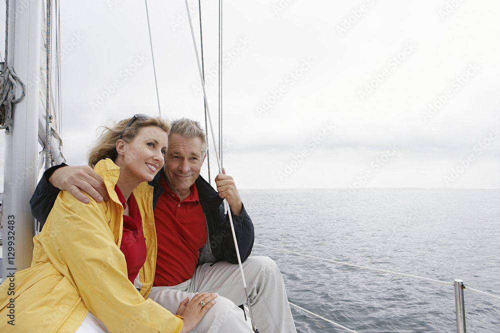 Happy Caucasian couple on sailboat