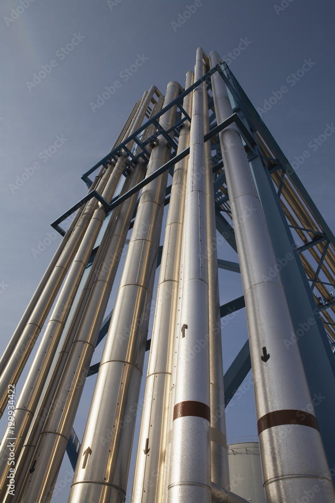 Low angle view of fuel oil supply pipes to power station against sky
