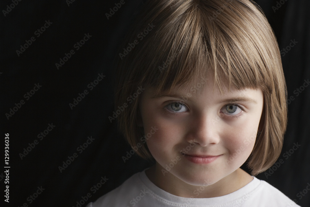 Closeup portrait of adorable little girl smiling isolated on black background Closeup portrait of adorable little girl smiling isolated on black background