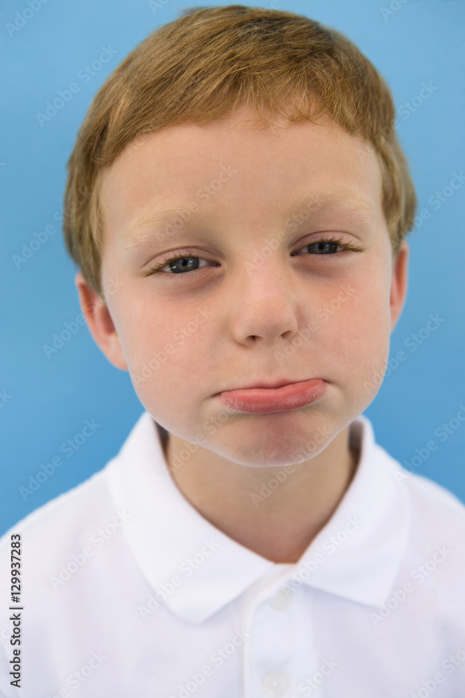 Portrait of cute little boy in casual white t-shirt making face isolated over colored background Portrait of cute little boy in casual white t-shirt making face isolated over colored background