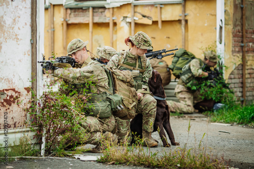 Soldiers on patrol in destroyed city. Military and rescue operation