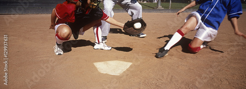 Photography Low section of players playing baseball on field