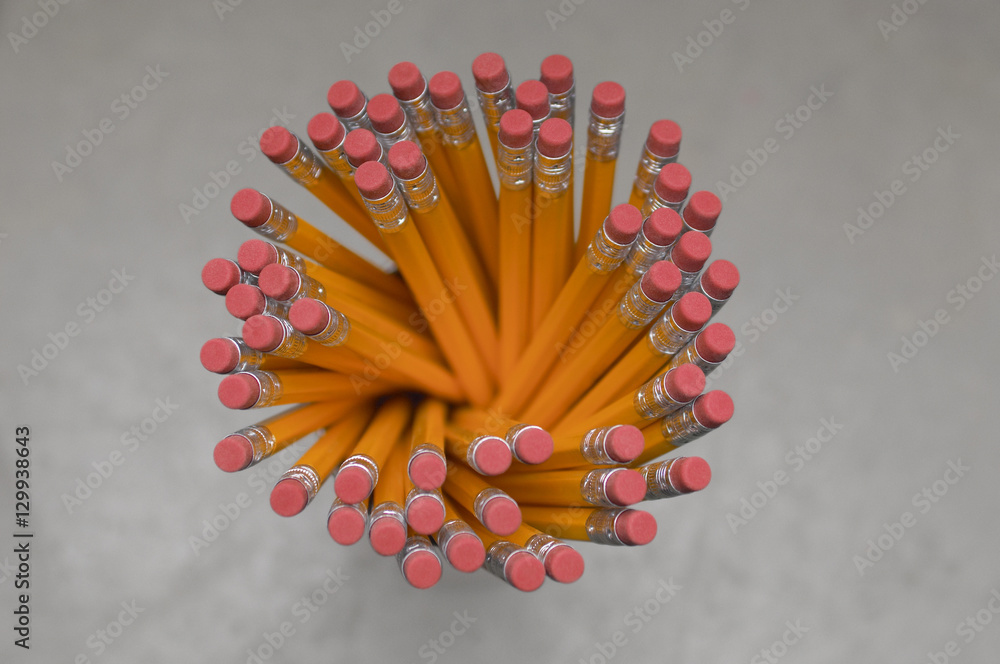 Top view of pencils in holder over grey background