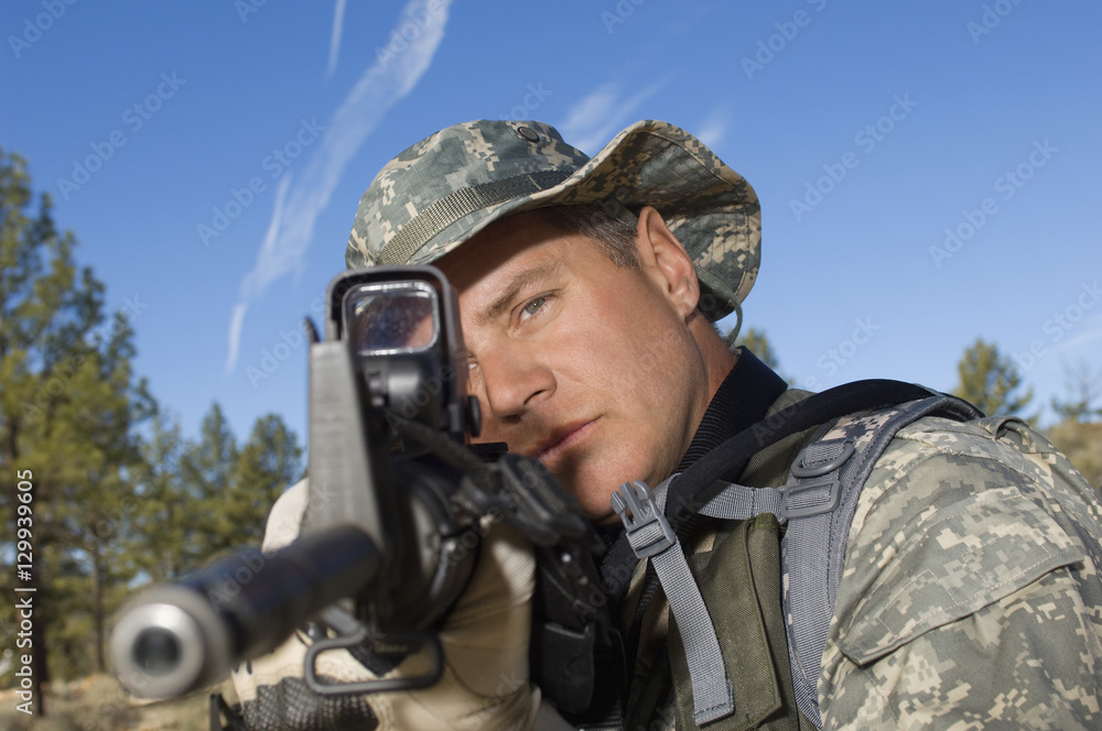 US army soldier aiming with a machine gun