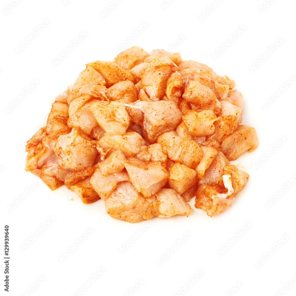 Raw chicken fillet cutted into pieces and spiced isolated over white background Raw chicken fillet cutted into pieces and spiced isolated over white background