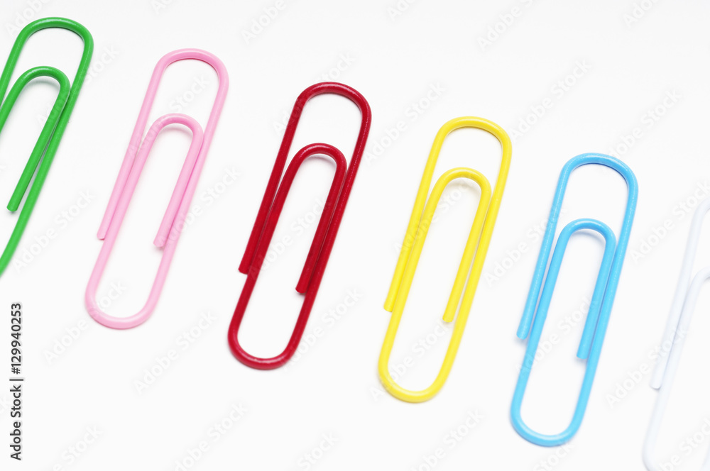 Row of multicolored paperclips over white background Row of multicolored paperclips over white background