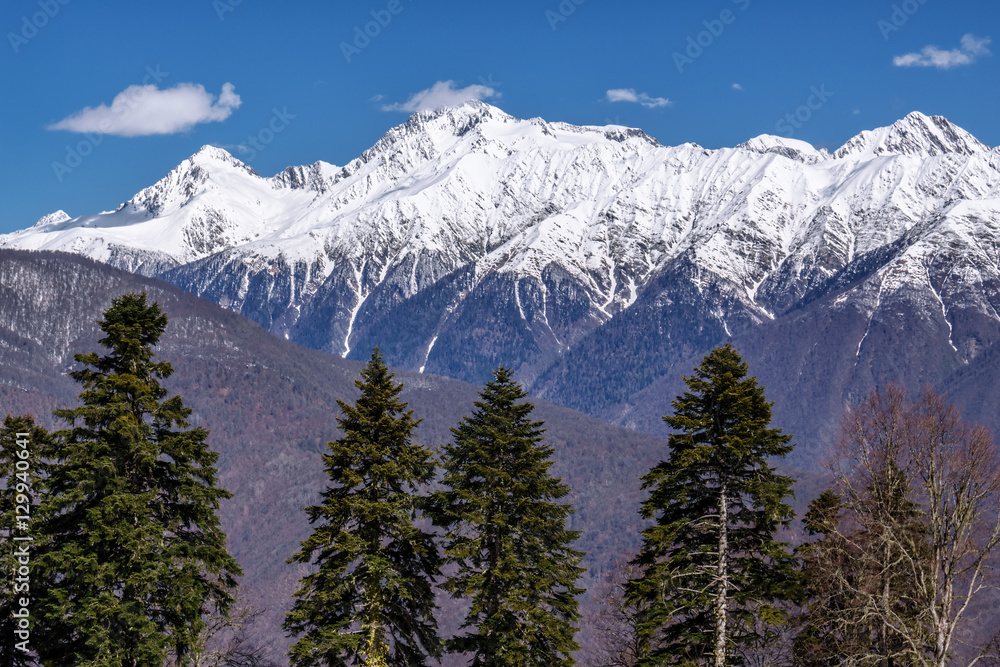 Beautiful mountain scenery of the Main Caucasian ridge with snowy peaks at winter Beautiful mountain scenery of the Main Caucasian ridge with snowy peaks at winter