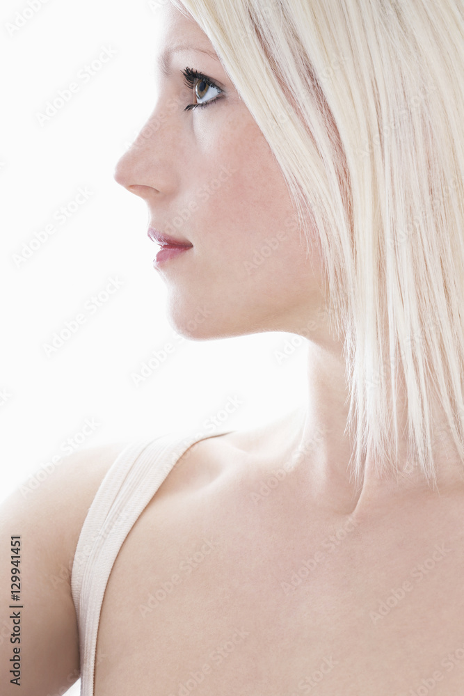 Closeup of beautiful woman looking away isolated over white background