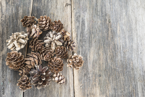 Fir,pine cones on old wooden background with space for text