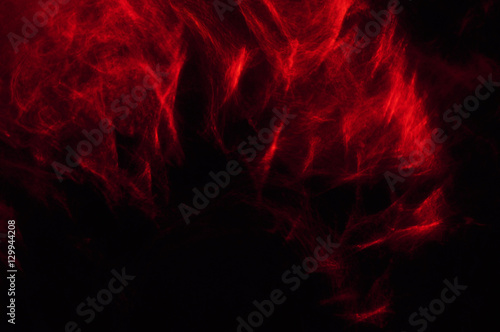 Abstract composition of red smoke in the dark