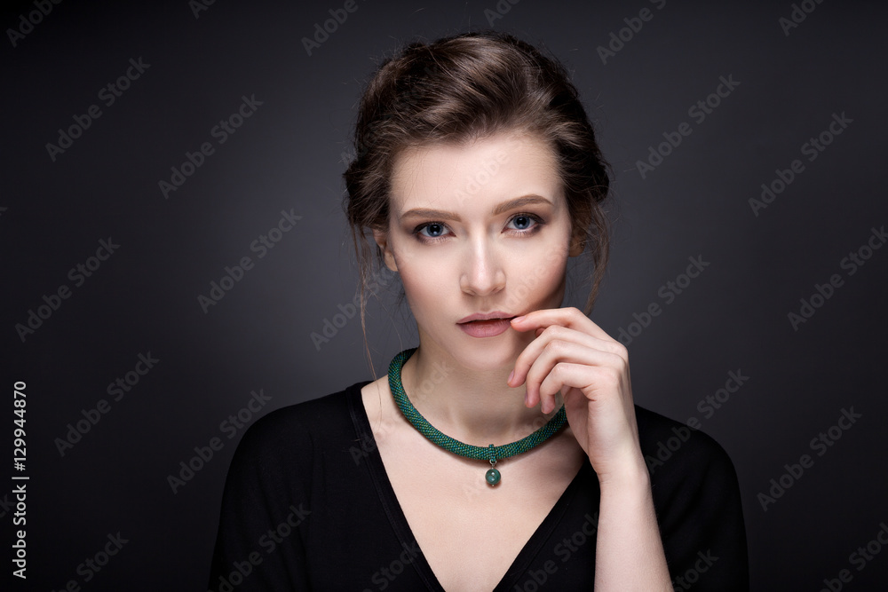 Portrait of a young girl with expressive eyes on a dark backgrou Portrait of a young girl with expressive eyes on a dark backgrou
