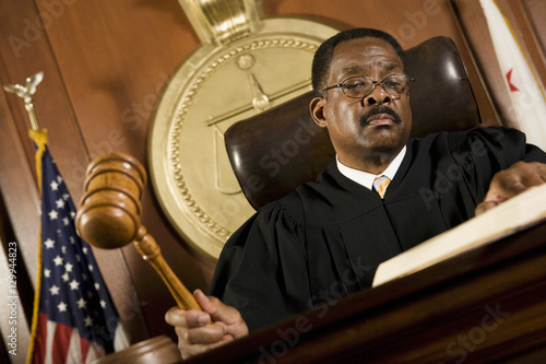 Fotografie An African American male judge forming sentence in the courtroom