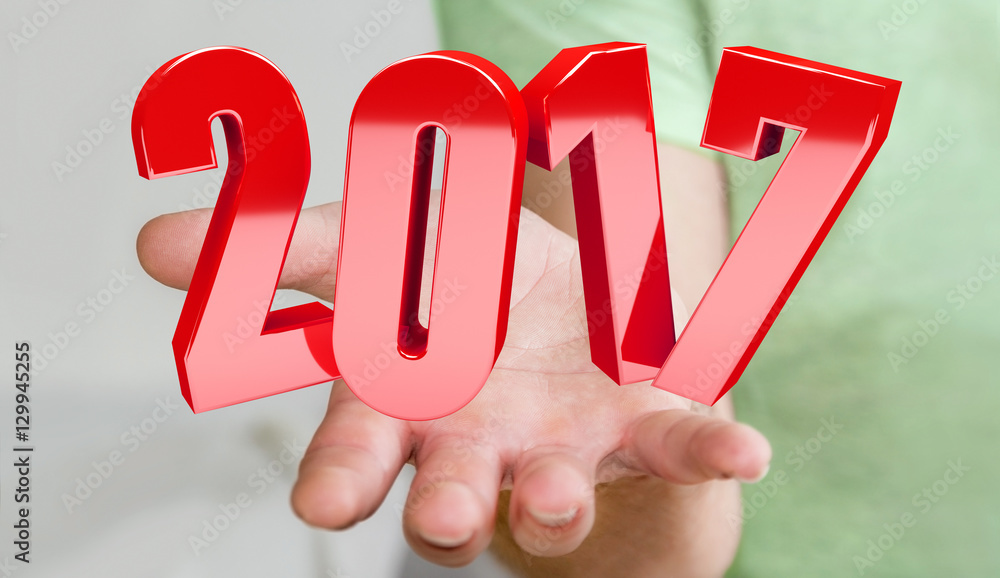 Businessman holding 2017 3D rendering text Businessman holding 2017 3D rendering text