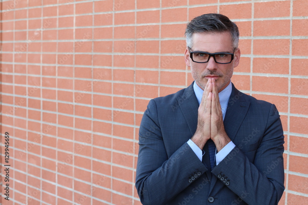 Portrait of mature man praying with copy space Portrait of mature man praying with copy space