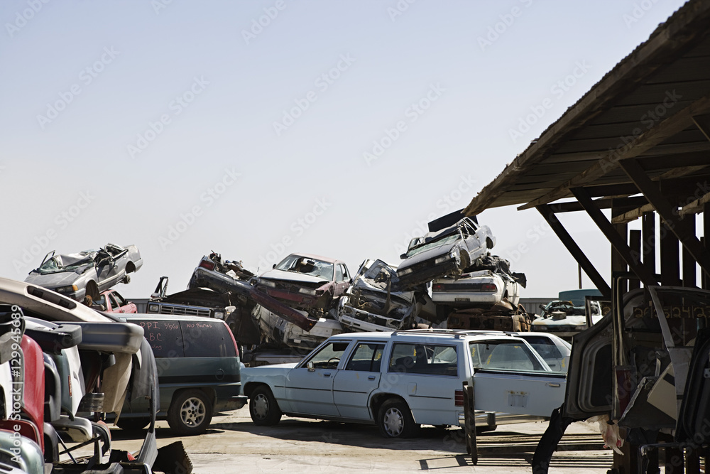 Fototapeta premium Cars stacked in junkyard