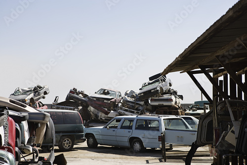 Cars stacked in junkyard