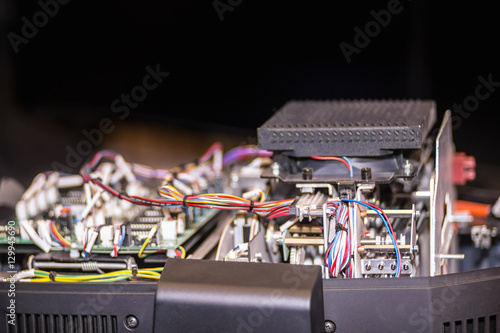 Inside of an opened electric device with wires, radio elemen