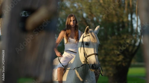 CLOSE UP: Gentle girl in white dress bareback riding beautiful white mare