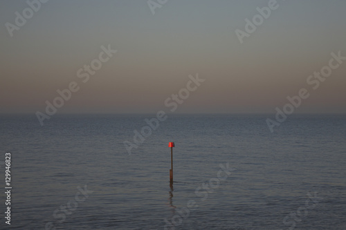 Beacon in ocean at dusk © moodboard