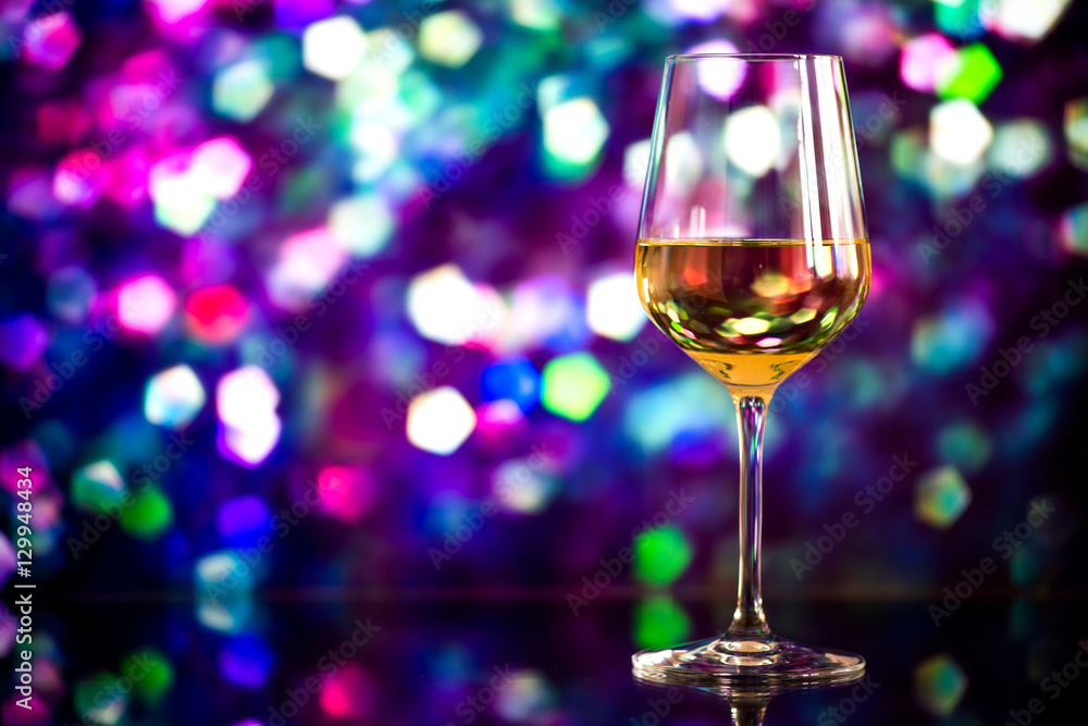 glass of white wine against a glowing bokeh - copy space, select glass of white wine against a glowing bokeh - copy space, select