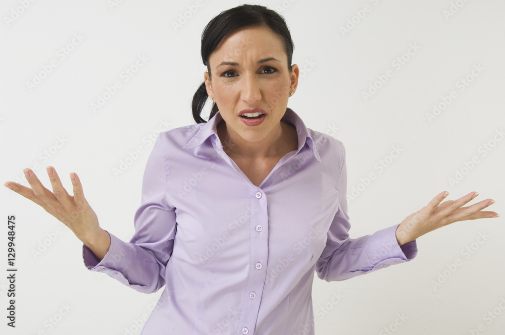 Portrait of an angry business woman shrugging over white background Portrait of an angry business woman shrugging over white background