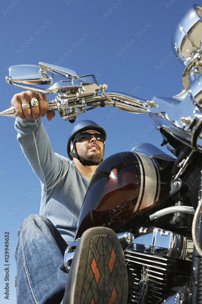Closeup of biker on bike against clear sky