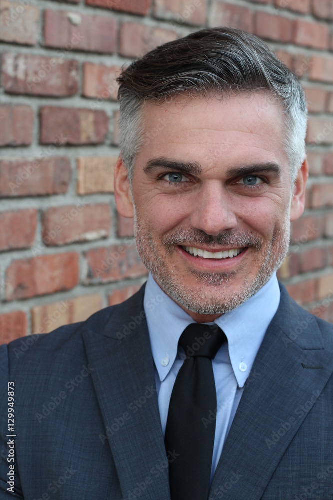 Mature businessman smiling wearing classic suit Mature businessman smiling wearing classic suit