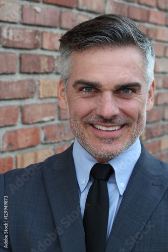 Mature businessman smiling wearing classic suit