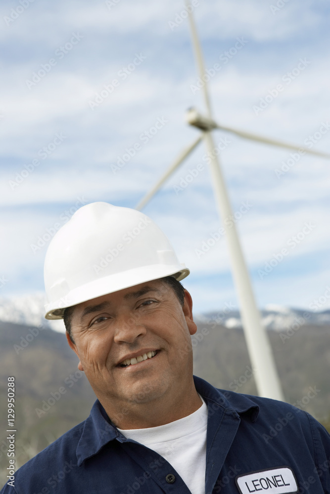Portrait of a happy engineer wearing hardhat at wind farm Portrait of a happy engineer wearing hardhat at wind farm