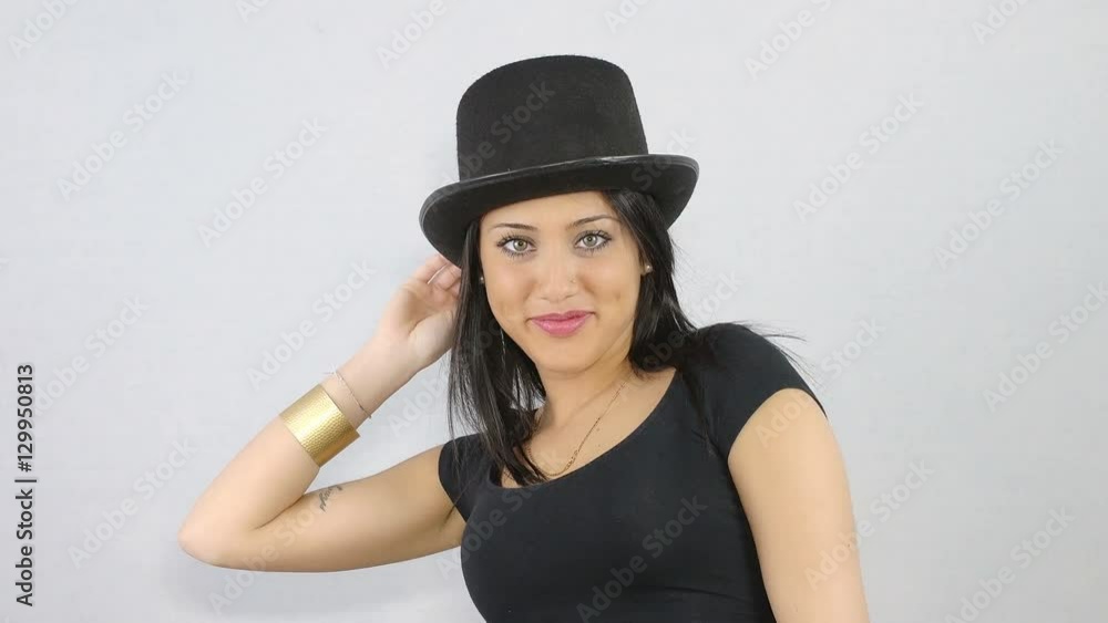 young woman wearing a hat and signs off with a hand smiling at the camera young woman wearing a hat and signs off with a hand smiling at the camera