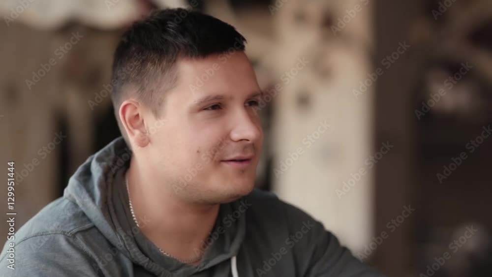 Handsome man smiles as he talks to someone. Having conversation. Handsome man smiles as he talks to someone. Having conversation.