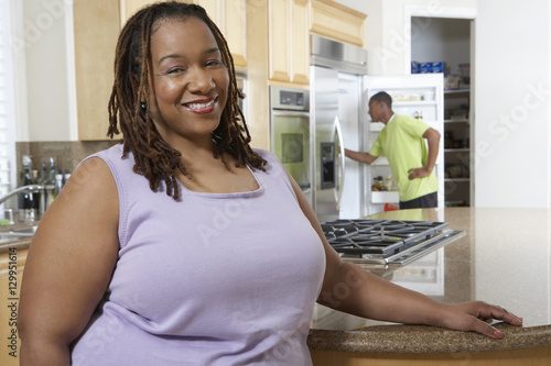 Portrait of an obese African American woman smiling with boy in the background