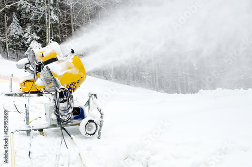 Yellow snow maker machine (snow gun, snow cannon) at ski slopes