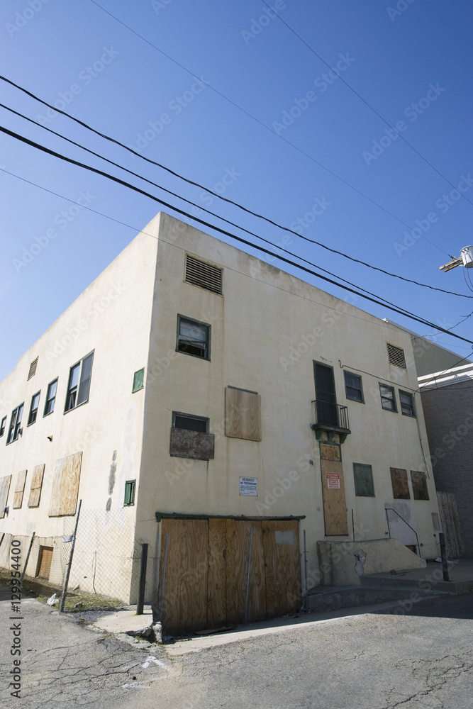 Exterior of an abandoned building boarded up windows