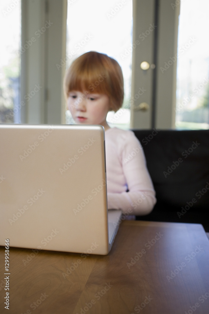 Young girl using laptop at home Young girl using laptop at home