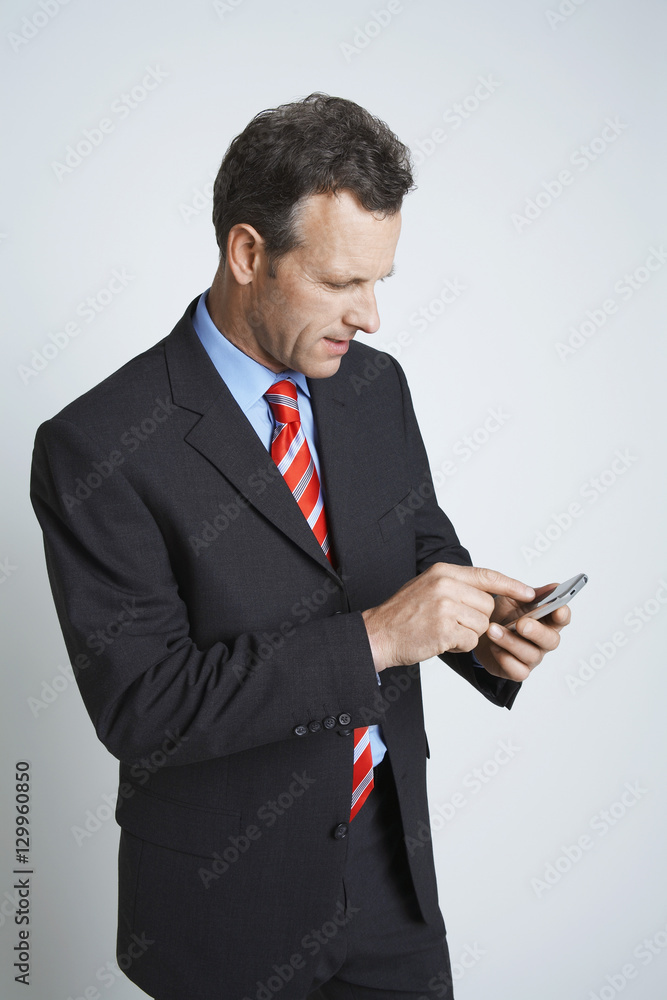 Businessman using cell phone isolated over white background Businessman using cell phone isolated over white background