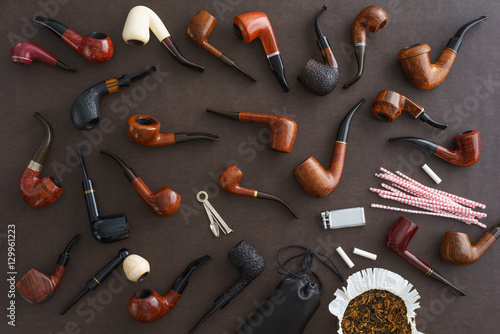 Collection of pipes and pipe smoking utensils photo