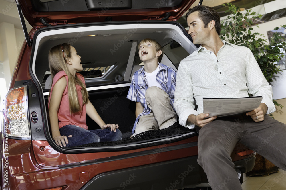 Children with their father sitting in the car Children with their father sitting in the car