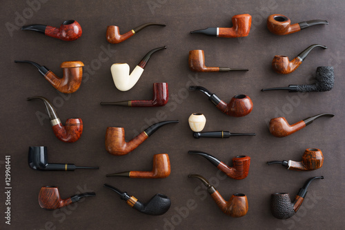 Fotografia Collection of pipes on brown faux leather