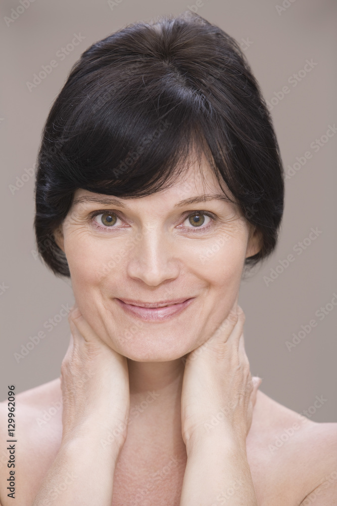 Closeup portrait of a young woman against pink background Closeup portrait of a young woman against pink background