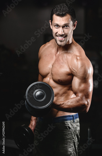 man with weight training in gym equipment sport club