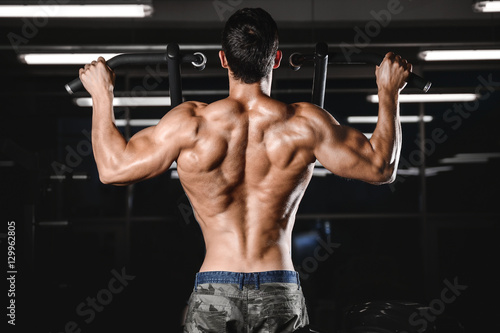 man with weight training in gym equipment sport club