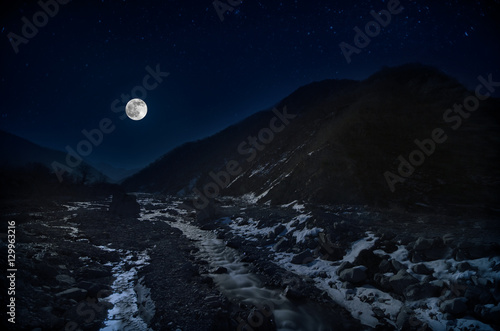 full moon over mountain and river snowy landscape in Azerbaijan winter night