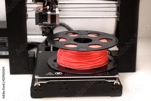 3d printer is on a table with plastic coral