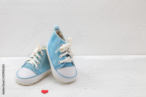  little baby shoes on white background