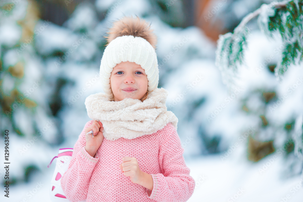 Portrait of adorable little girl going skating in winter snow day outdoors Portrait of adorable little girl going skating in winter snow day outdoors